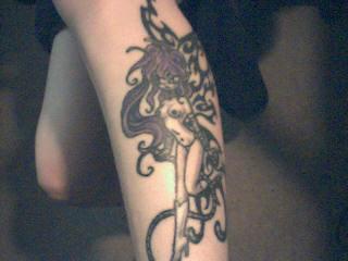 my bondage faerie tattoo on lower left outside calve
